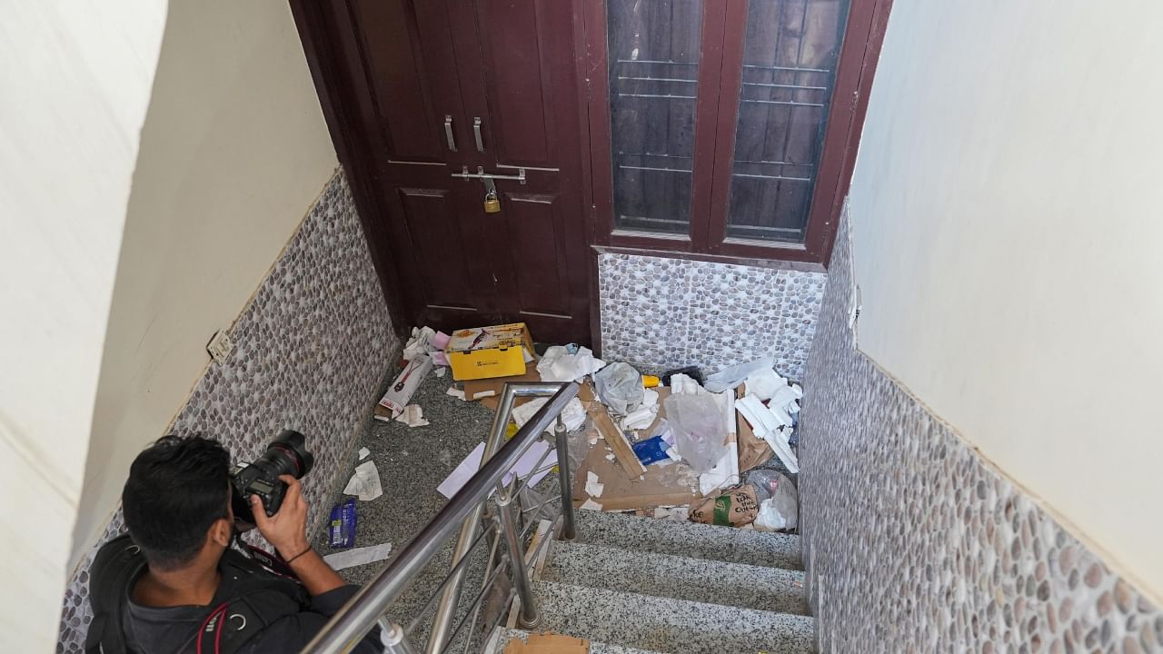 A cameraperson clicks pictures outside the flat in which Aftab Poonawalla and his live-in partner Shraddha Walkar used to reside. Credit: PTI Photo