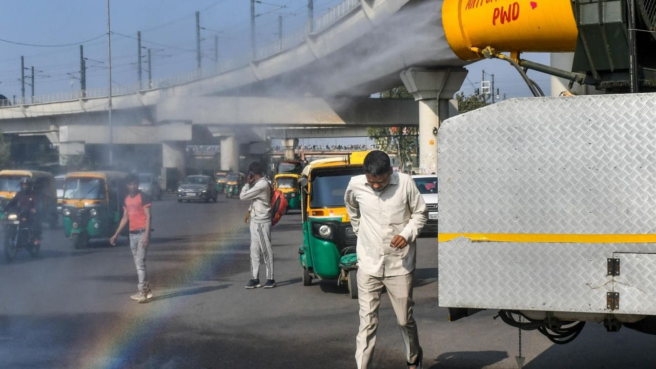 An anti-smog gun being used to spray water droplets to curb air pollution, in New Delhi. Photo Credit: PTI Photo