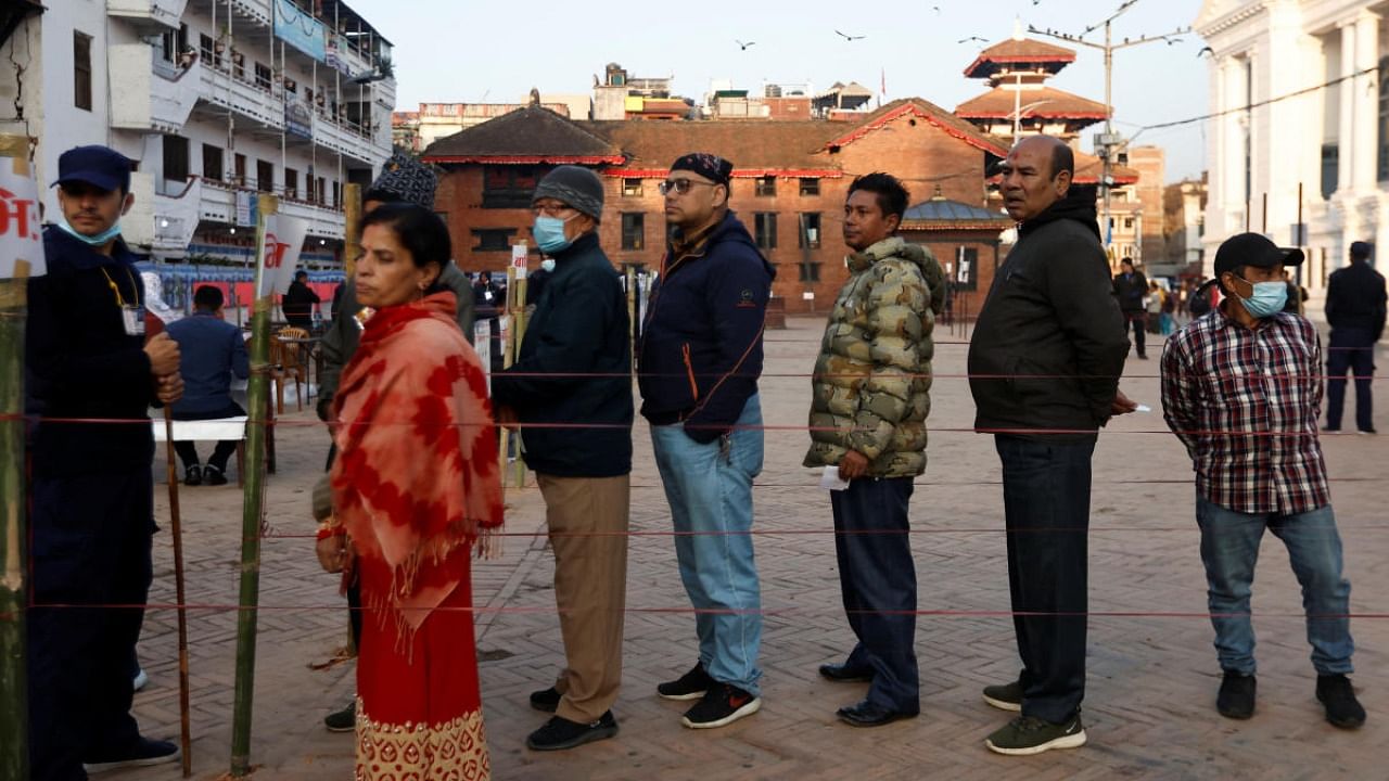 People stand in a queue to cast their votes during the general election, in Kathmandu. Credit: Reuters photo