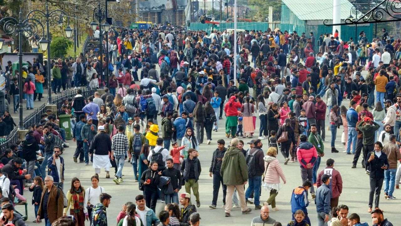  Tourists walk along the Ridge during the onset of winter season, in Shimla. Photo Credit: PTI Photo