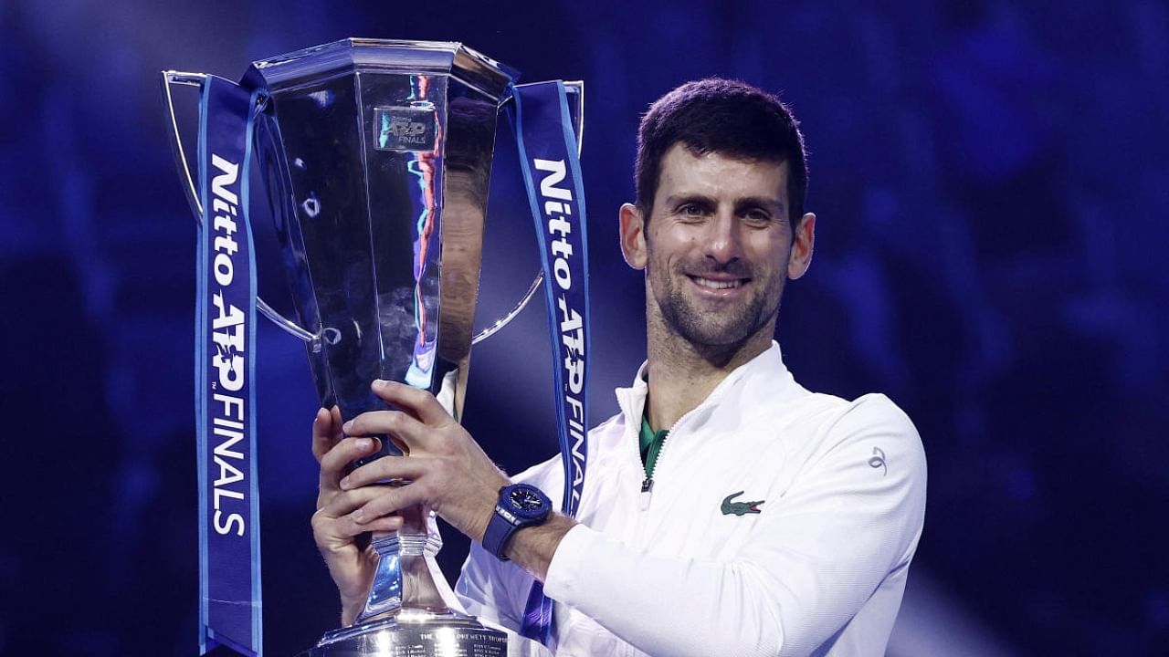 Serbia's Novak Djokovic celebrates with the trophy after winning the men's singles final against Norway's Casper Ruud. Credit: Reuters Photo