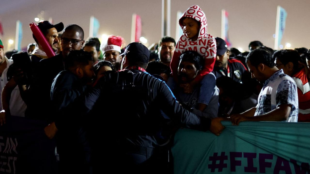 Barriers are held by police officers as fans move away from a crowd gathered at the fan festival. Credit: Reuters Photo