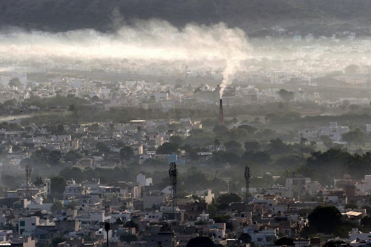 Smoke billows from a factory chimney during a smoggy morning in Ajmer. FIle Photo / AFP