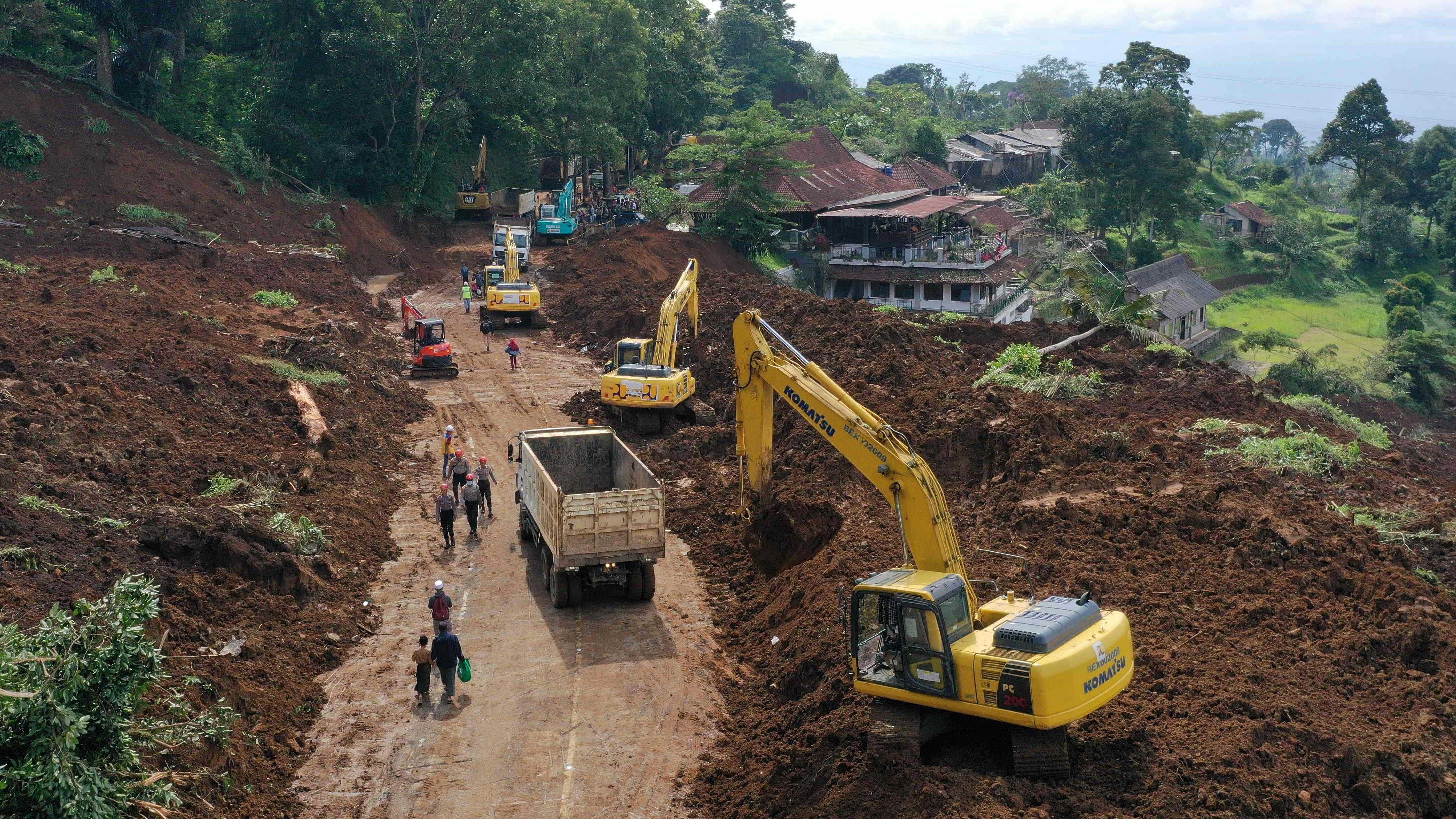 Workers using heavy equipments to remove soil following landslide triggered by a 5.6-magnitude earthquake near Cianjur on November 22, 2022. Credit: AFP Photo
