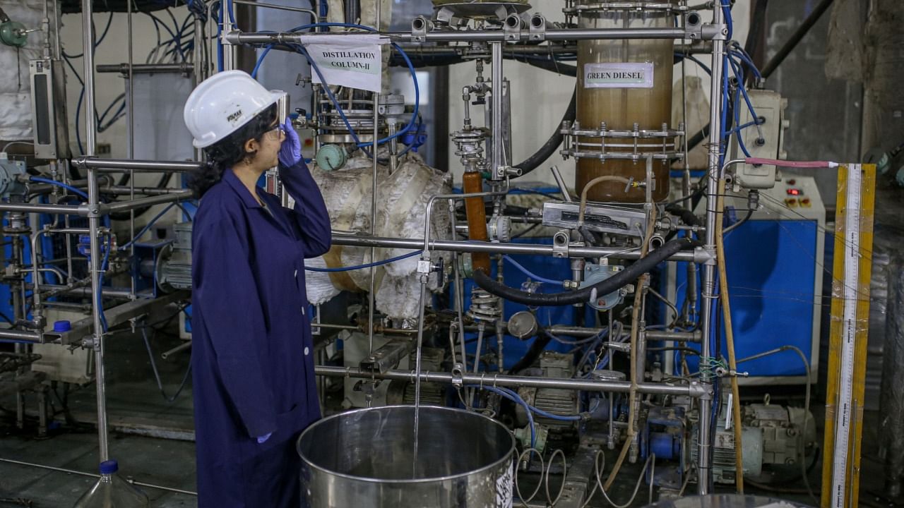 A worker observes the bio jet fuel production at Council Of Scientific And Industrial Research, Indian Institute of Petroleum in Dehradun, India, on Friday, Oct. 7, 2022. Credit: Bloomberg Photo