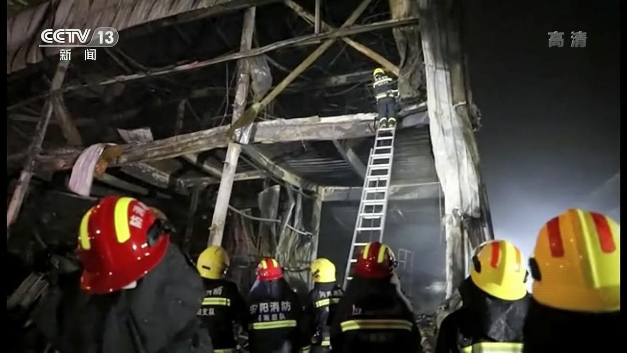 Image from video footage run by China's CCTV shows firefighters on site in Anyang. Credit: AP/PTI Photo