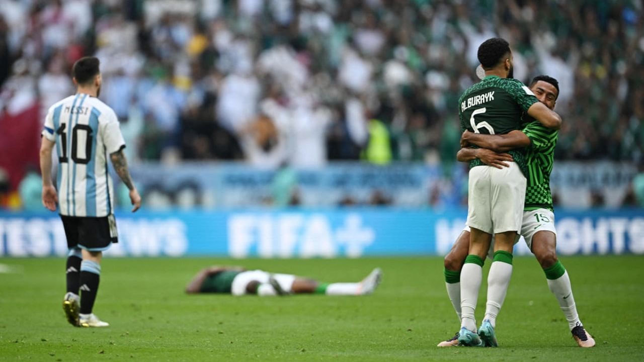 Argentina's Lionel Messi looks dejected after the match as Saudi Arabia celebrates. Credit: Reuters Photo