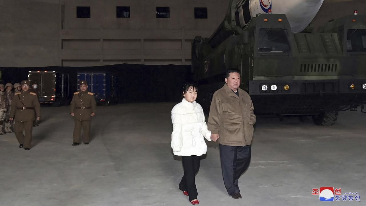 This photo provided on Nov. 19, 2022, by the North Korean government shows North Korean leader Kim Jong Un, right, and his daughter inspects a missile at Pyongyang International Airport. Credit: AP/PTI Photo