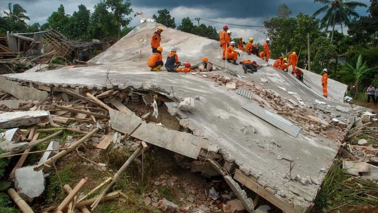 Rescue workers look for victims under the ruins of collapsed buildings in Cianjur. Credit: AFP Photo