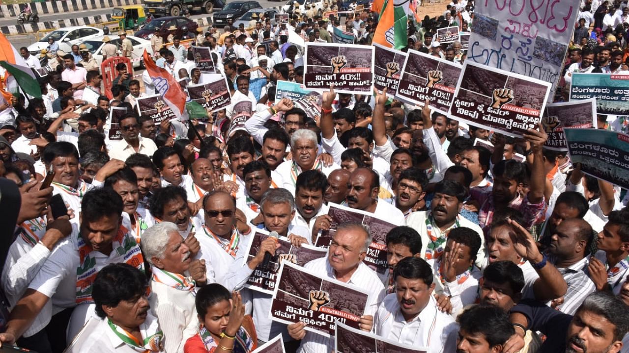 Senior Congress leaders and party workers stage a protest near Esteem Mall on Monday. Credit: DH Photo