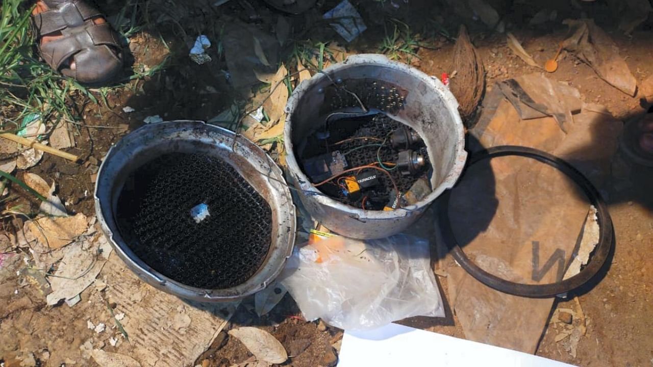 A cooker fitted with detonator, wires and batteries found during the investigation after the Mangaluru blast. Credit: PTI Photo