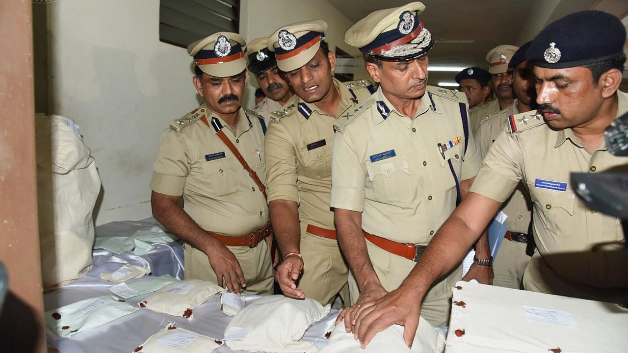 Additional Director General of Police Alok Kumar checks items recovered from the residence of Mohammed Shariq, suspect who allegedly carried out the Saturday's auto-rickshaw explosion, in Mangaluru, Monday, Nov. 21, 2022. Credit: PTI Photo
