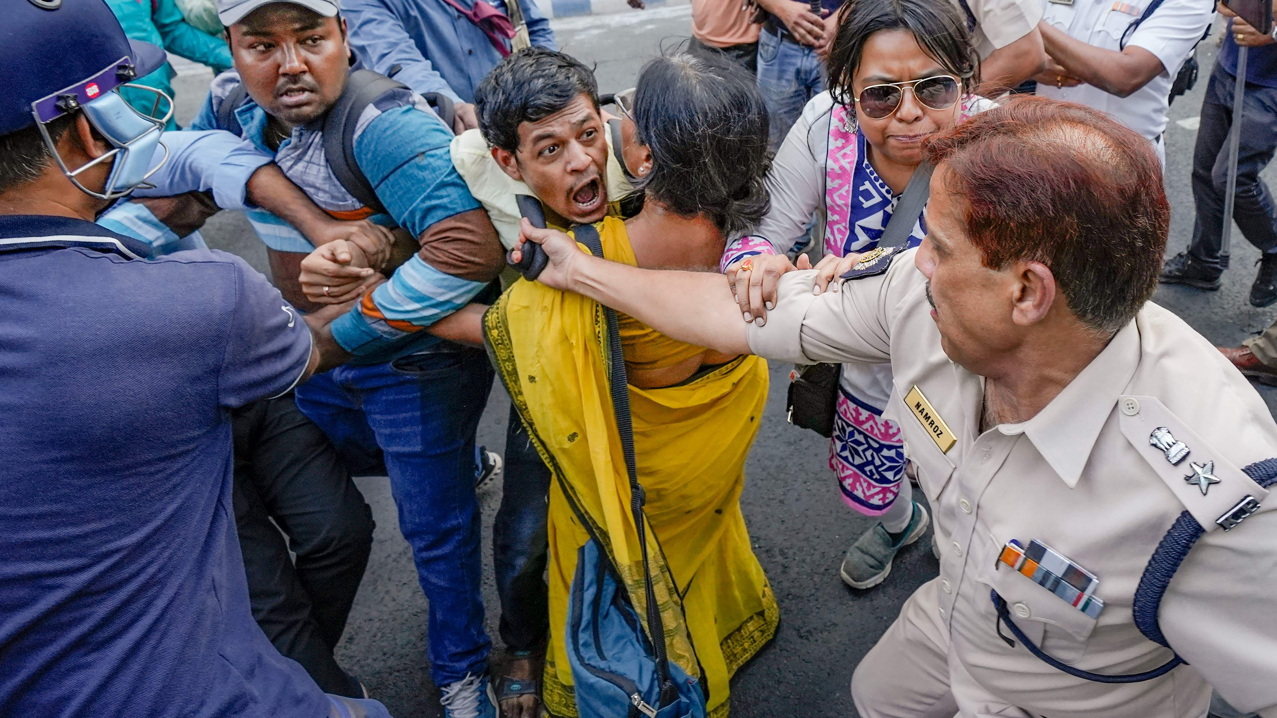  State government employees being detained by police personnel during their protest march towards West Bengal Assembly to demand clearance of their pending dearness allowance (DA). Credit: PTI Photo