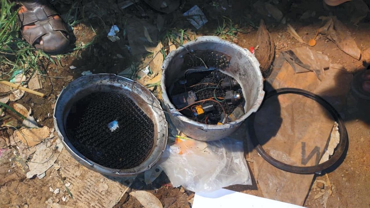 A cooker fitted with detonator, wires and batteries found during the investigation after Mangaluru blast. Credit: PTI Photo