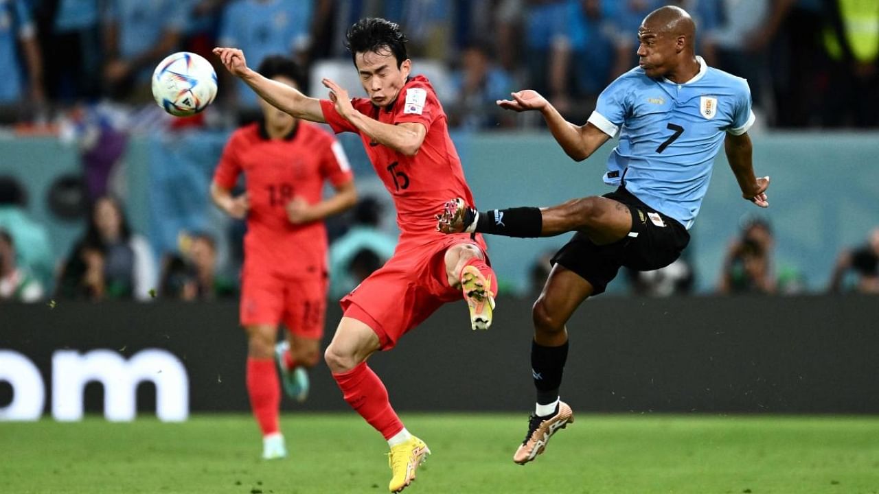 South Korea's Kim Moon-hwan fights for the ball with Uruguay's midfielder Nicolas De La Cruz. Credit: AFP Photo