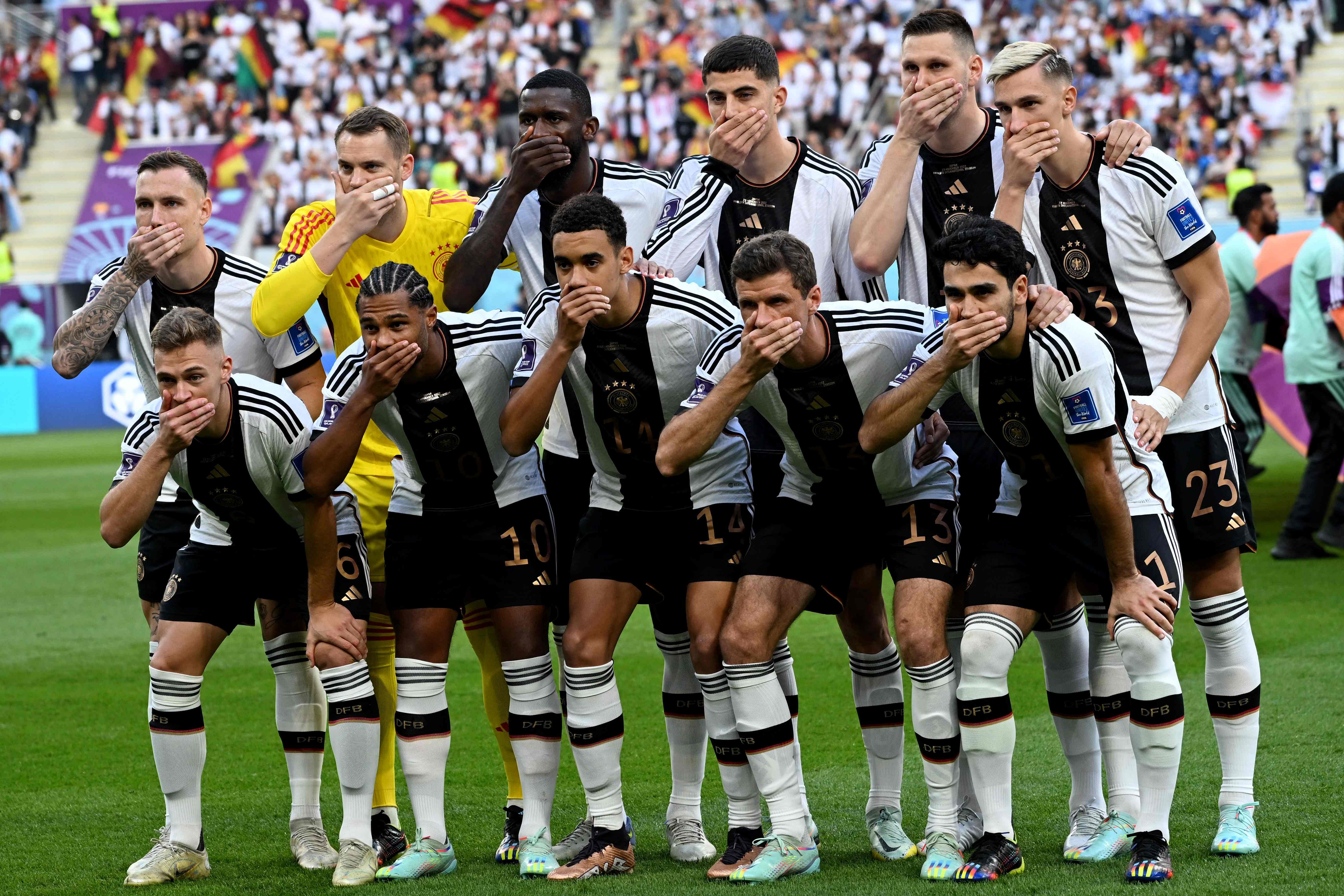 Players of Germany cover their mouths as they pose for the group picture ahead of the Qatar 2022 World Cup. Credit: AFP Photo