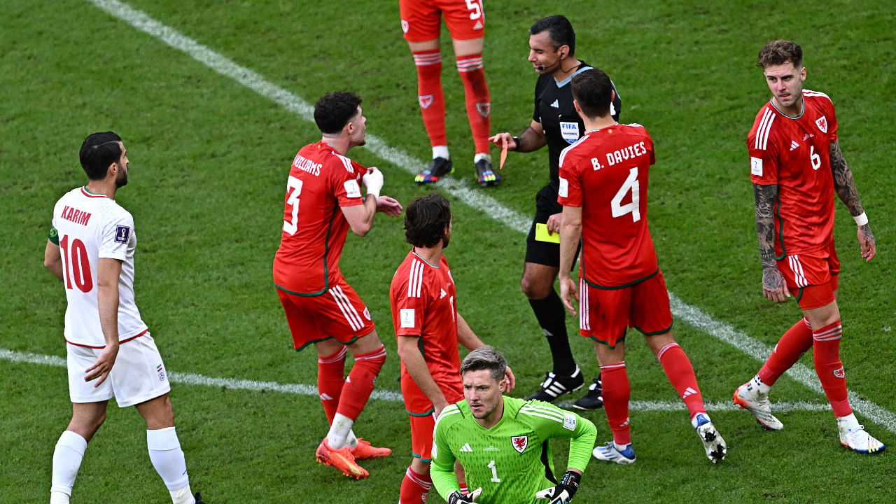 Guatemalan referee Mario Escobar shows a red card to Wales' goalkeeper #01 Wayne Hennessey after a VR review during the Qatar 2022 World Cup Group B football match . Credit: AFP Photo