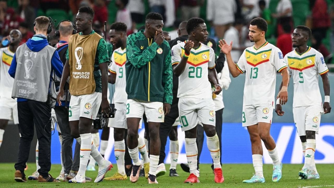 Players react after the final whistle of the Qatar 2022 World Cup Group A football match between Qatar and Senegal at the Al-Thumama Stadium in Doha. Credit: AFP Photo