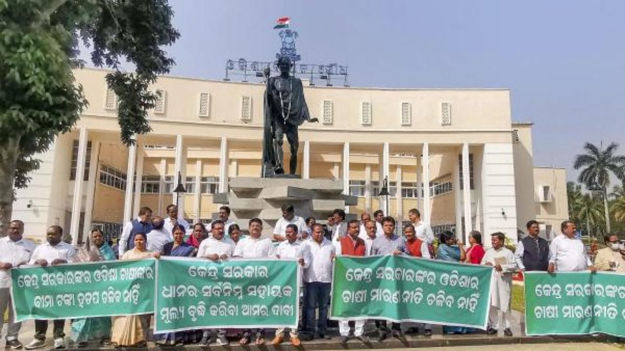  BJD MLAs stage a protest near Mahatma Gandhi statue during the winter session of Odisha Assembly. Credit: PTI Photo