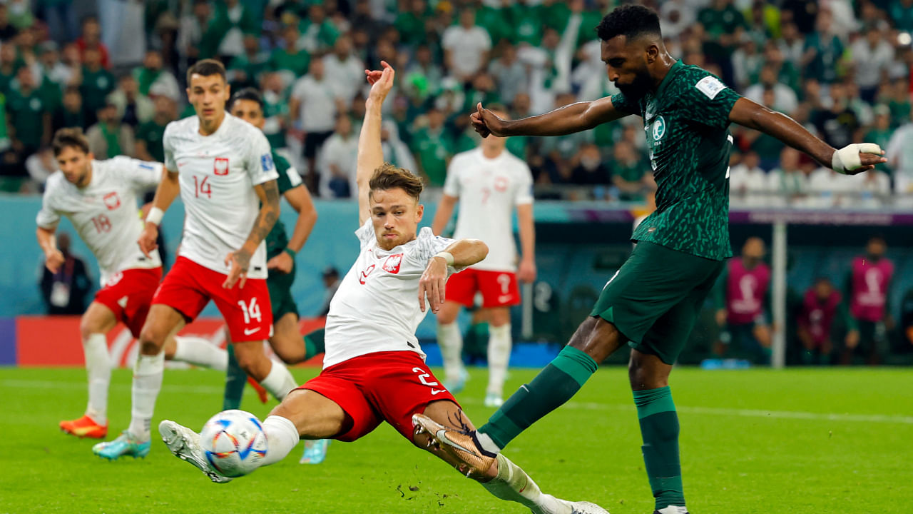 Poland's defender #02 Matthew Cash blocks Saudi Arabia's forward #09 Firas Al-Buraikan during the Qatar 2022 World Cup Group C football match between Poland and Saudi Arabia at the Education City Stadium in Al-Rayyan. Credit: AFP Photo