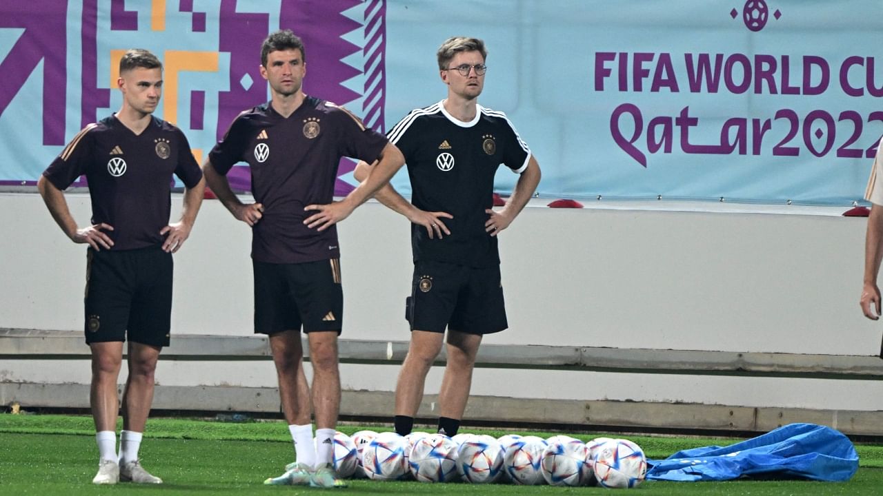 Germany’s Joshua Kimmich (L) and Thomas Mueller (C) attend a training session at Al Shamal Stadium in Al Shamal, north of Doha on November 25, 2022. Credit: AFP Photo