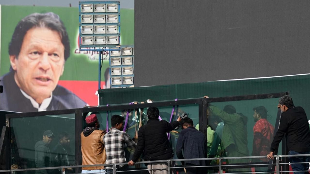 Supporters of Imran Khan install a bullet proof glass shield on the main stage ahead of anti-government rally in Rawalpindi. Credit: PTI Photo