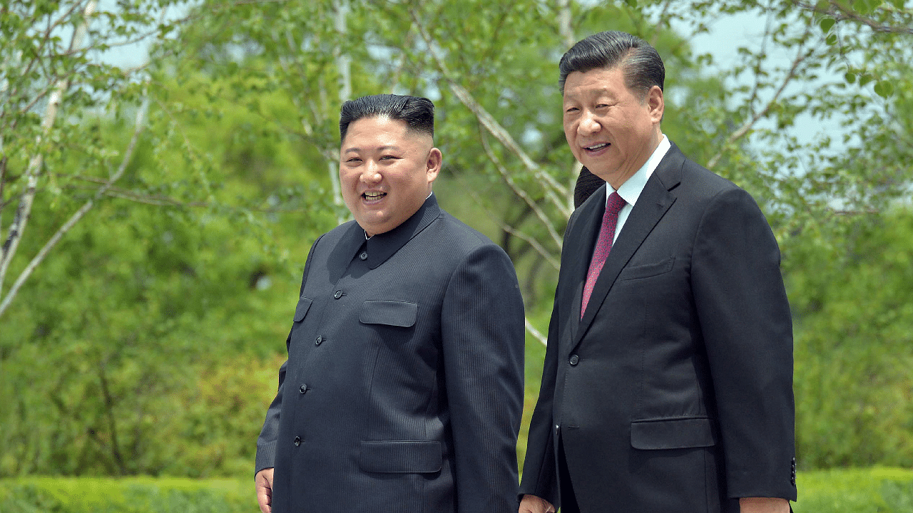 Chinese President Xi Jinping and North Korean leader Kim Jong Un walk during Xi's visit in Pyongyang. Credit: Reuters Photo