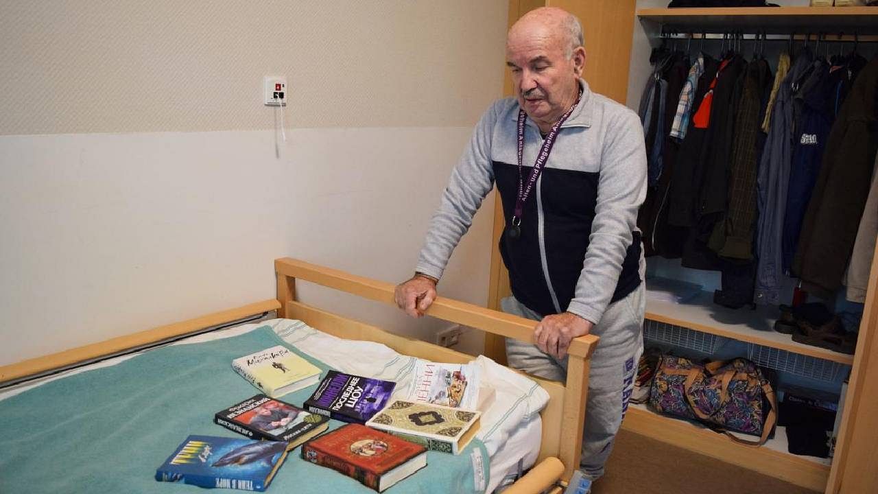 Ukrainian Holocaust survivor Borys Shyfrin is pictured in Frankfurt am Main, western Germany, on November 2, 2022, with books in Russian that he enjoys reading. After fleeing from the Nazis as a young child, he has been forced from his home once more, this time finding refuge in Germany. Credit: AFP Photo