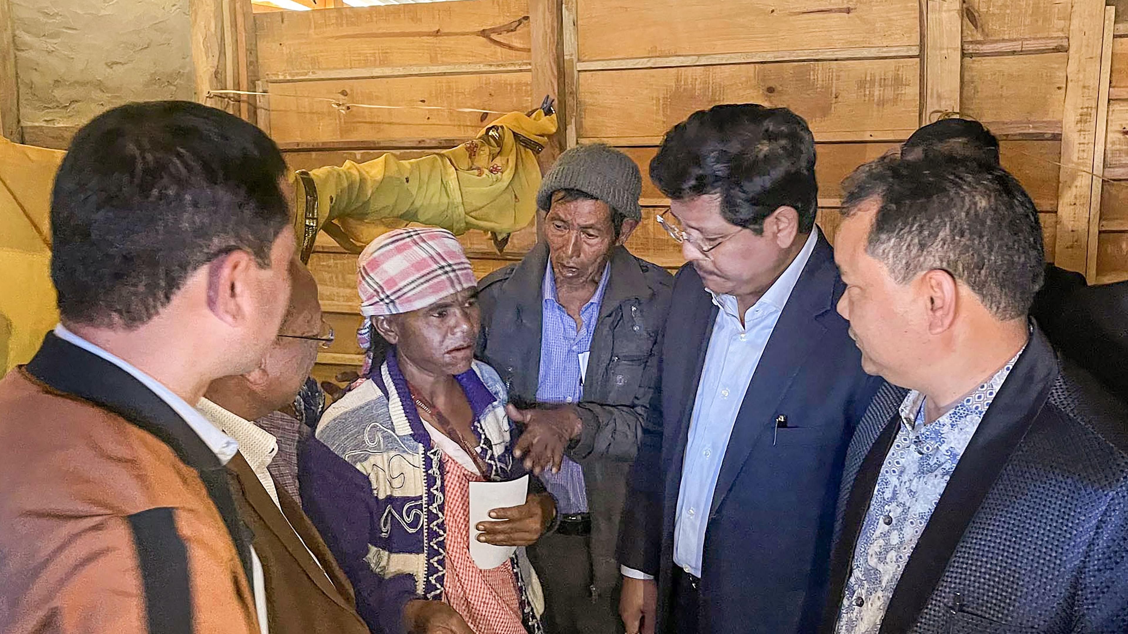 Meghalaya CM Conrad Sangma visit family members of victims killed in the Mukroh firing incident along the Assam-Meghalaya border. Credit: PTI Photo