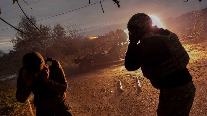 Ukrainian servicemen fire towards Russian positions in the frontline near Kherson. Credit: AP/PTI Photo