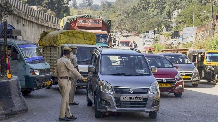 Assam Police personnel stop Meghalaya-bound vehicles along Assam-Meghalaya border. Credit: PTI Photo