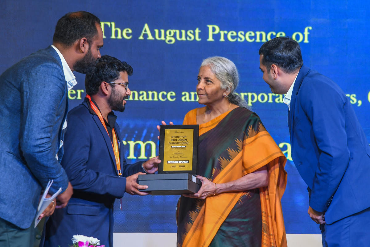 Union Finance Minister Nirmala Sitharaman felicitates Karthik Vignesh S, head, Business and Strategy CoRE, at the Start0up Inclusion Summit organised by Vananam in Bengaluru on Saturday. Credit: DH Photo