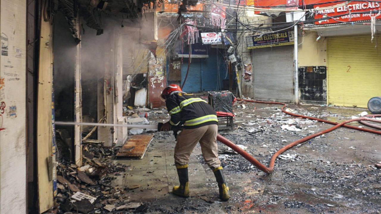 Fire Brigade personnel try to douse a massive fire that broke out at the Bhagirath Palace market, in Delhi, Friday, Nov. 25, 2022. The fire broke out Thursday night. Credit: PTI Photo