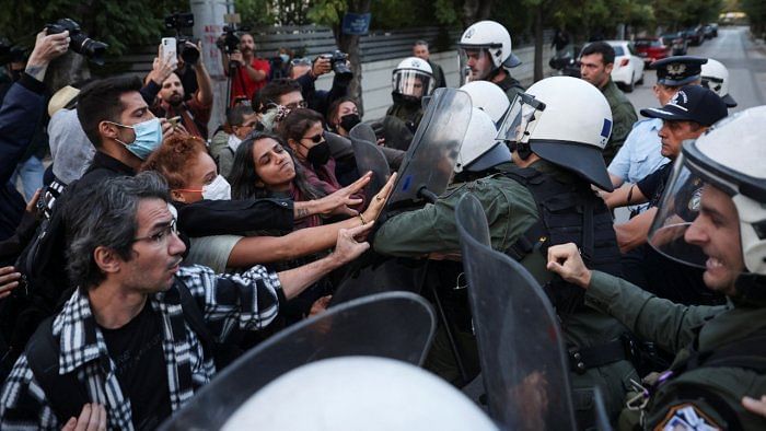 Demonstrators scuffle with riot police, during a protest following the death of Mahsa Amini. Credit: Reuters Photo