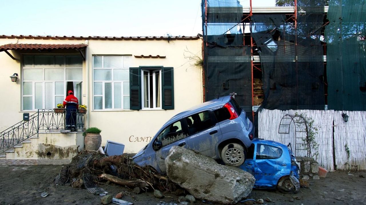 A rescuer checks a damaged house following heavy rains that caused a landslide on the island of Ischia. Credit: AFP Photo