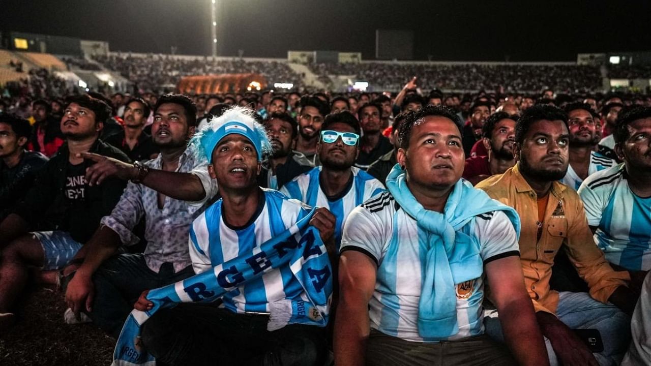 Qatar's migrant workers watch a World Cup match on the outskirts of Doha during the Qatar World Cup 2022. Credit: AFP Photo