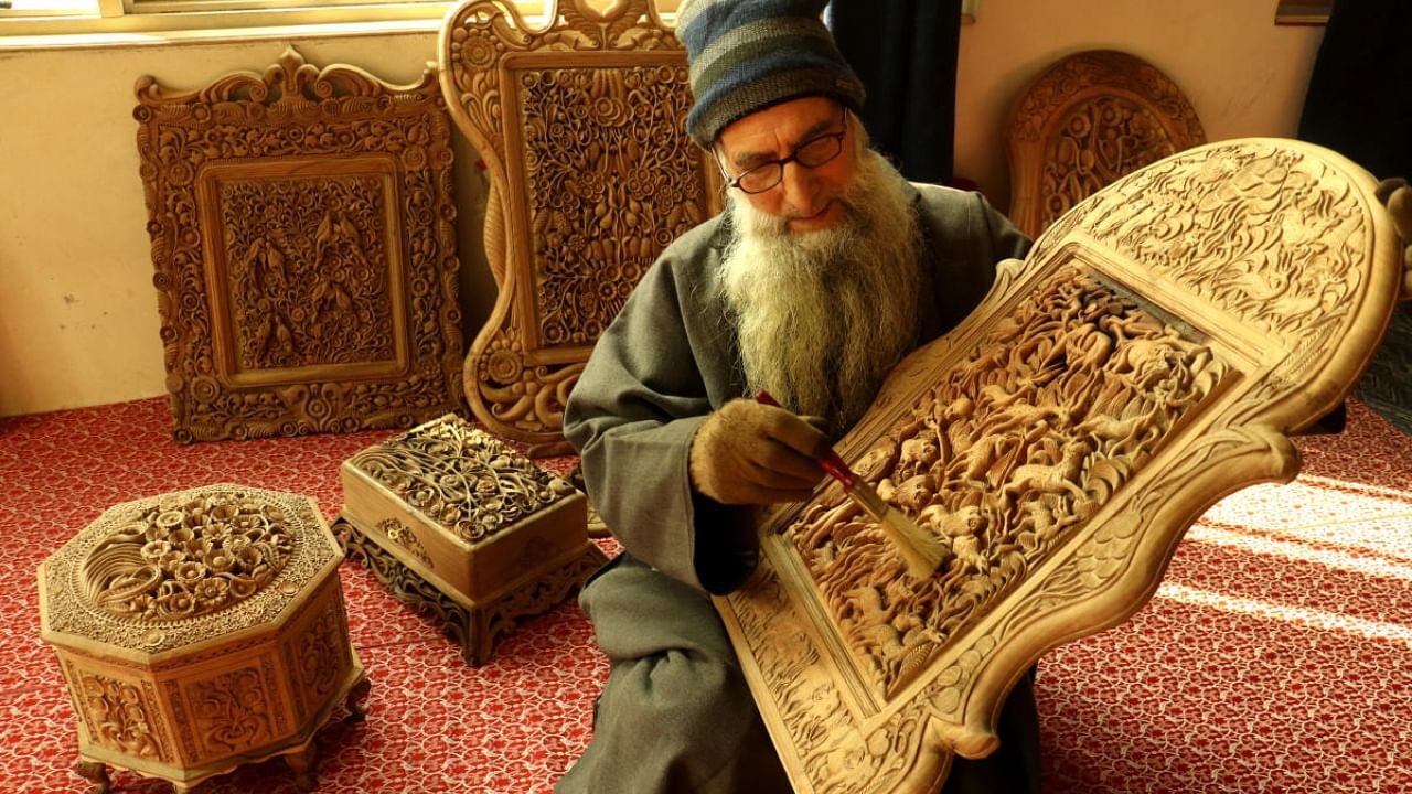A craftsman working on a walnut wood carving in Srinagar. Credit: Special Arrangement