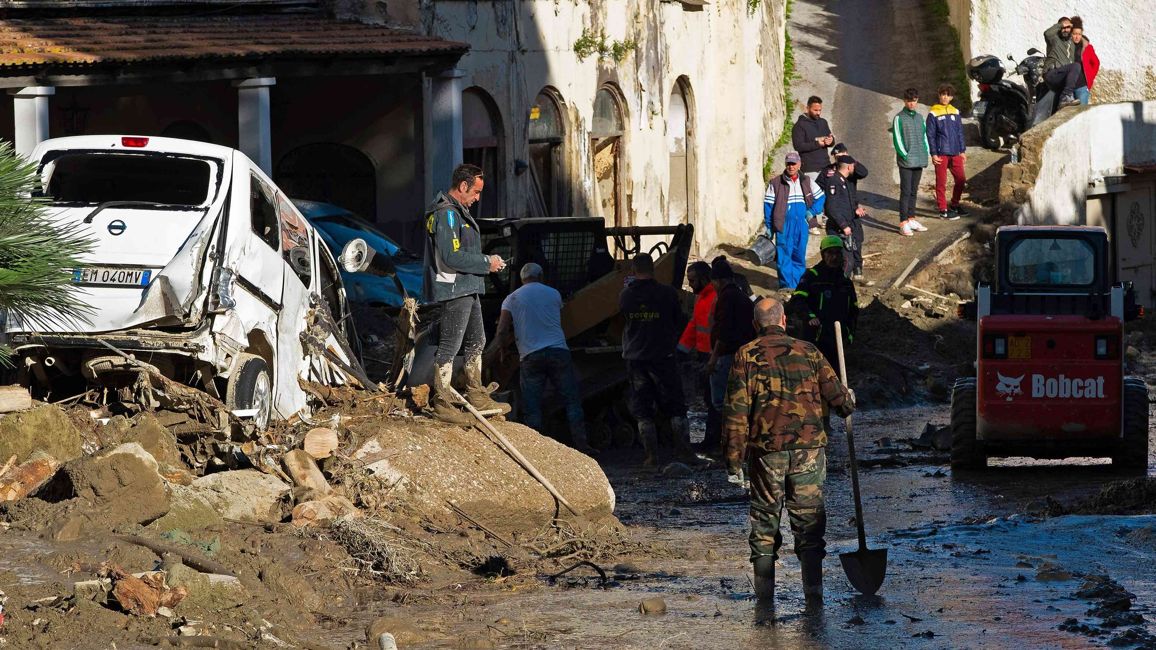 People work on the damaged street in Casamicciola, following heavy rains that caused a landslide. Credit: AFP Photo