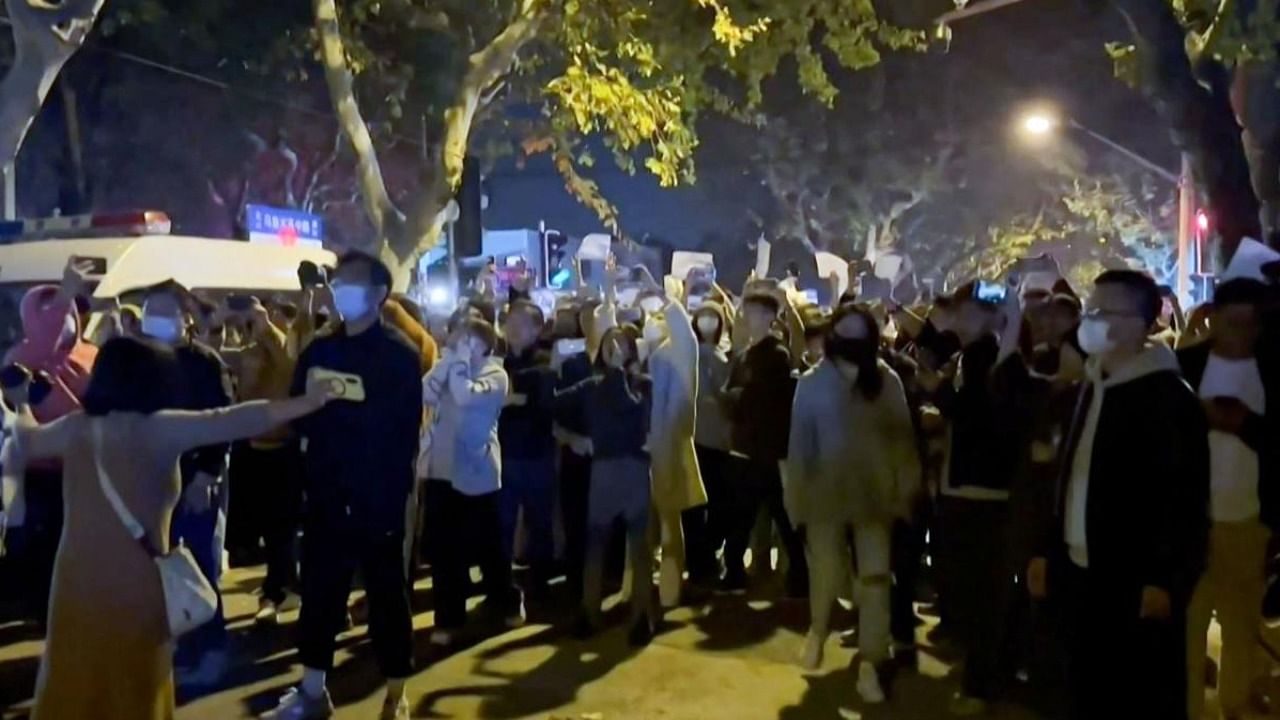  Angry crowds took to the streets in Shanghai in the early hours of Sunday and protested against Covid-19 curbs. Credit: AFP Photo