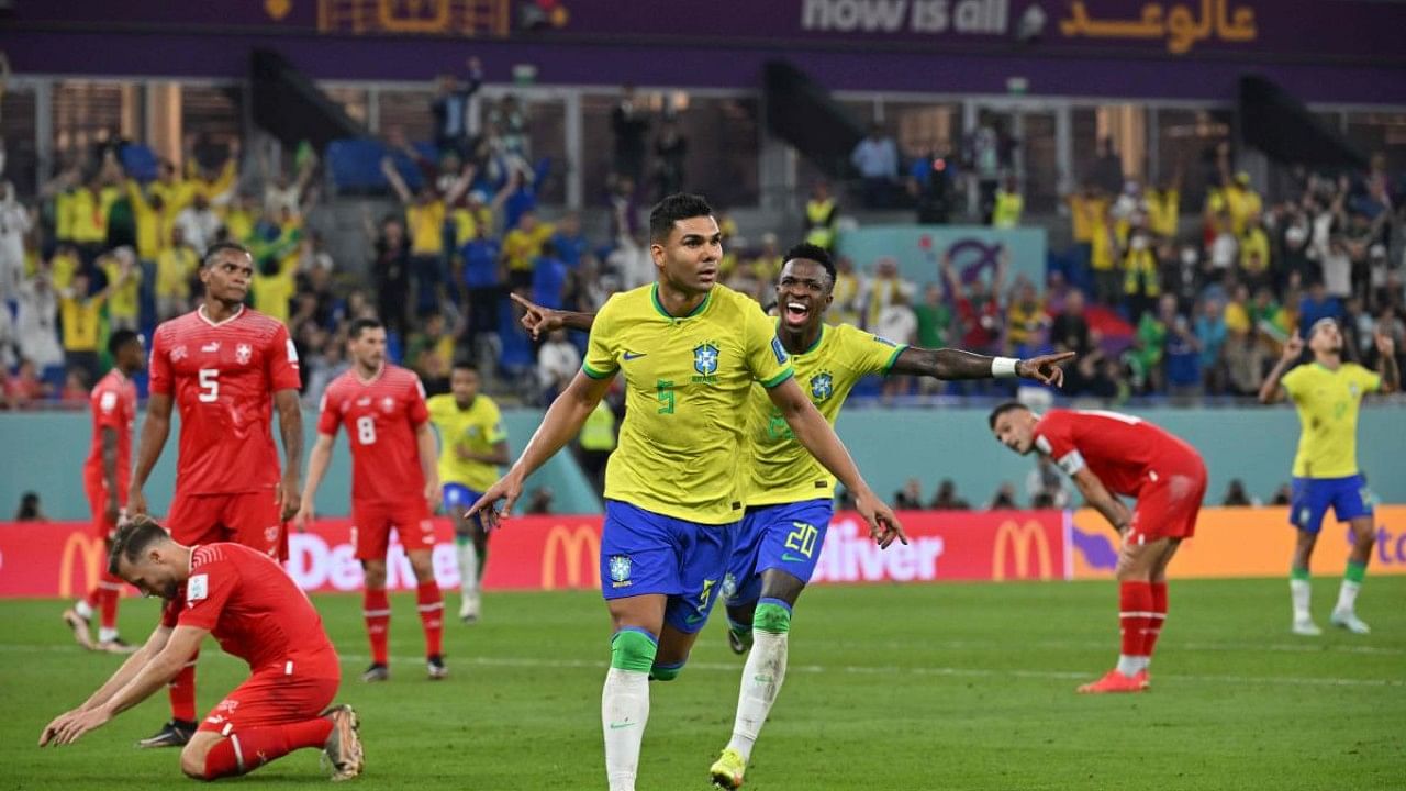 Brazil's midfielder #05 Casemiro (L) celebrates with Brazil's forward #20 Vinicius Junior after he scored his team's first goal during the Qatar 2022 World Cup. Credit: AFP Photo