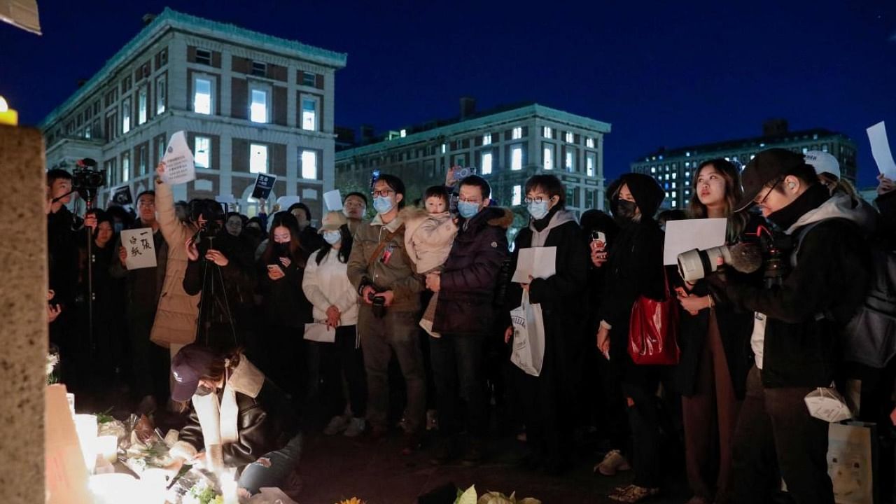 People gather at Columbia University during a protest in support of demonstrations held in China calling for an end to Covid-19 lockdowns, in New York. Credit: AFP