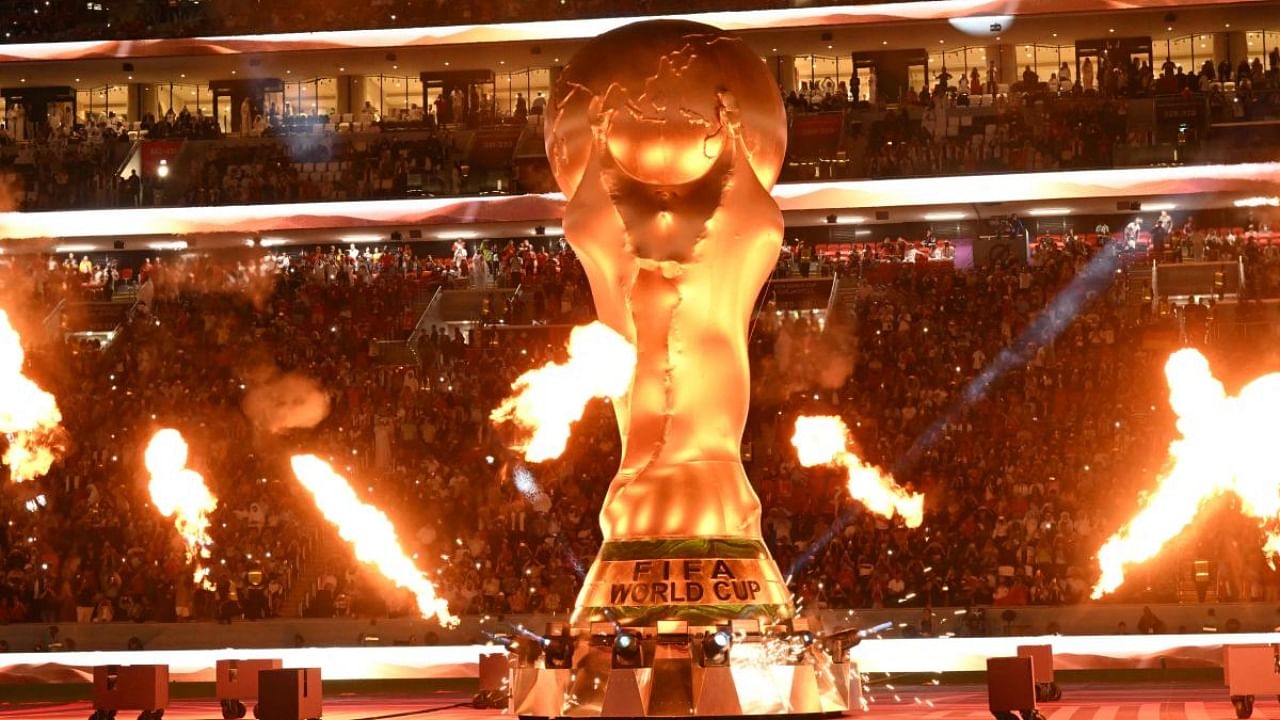 Repica of the World Cup seen on the pitch before a group stage match in Qatar. Credit: AFP Photo