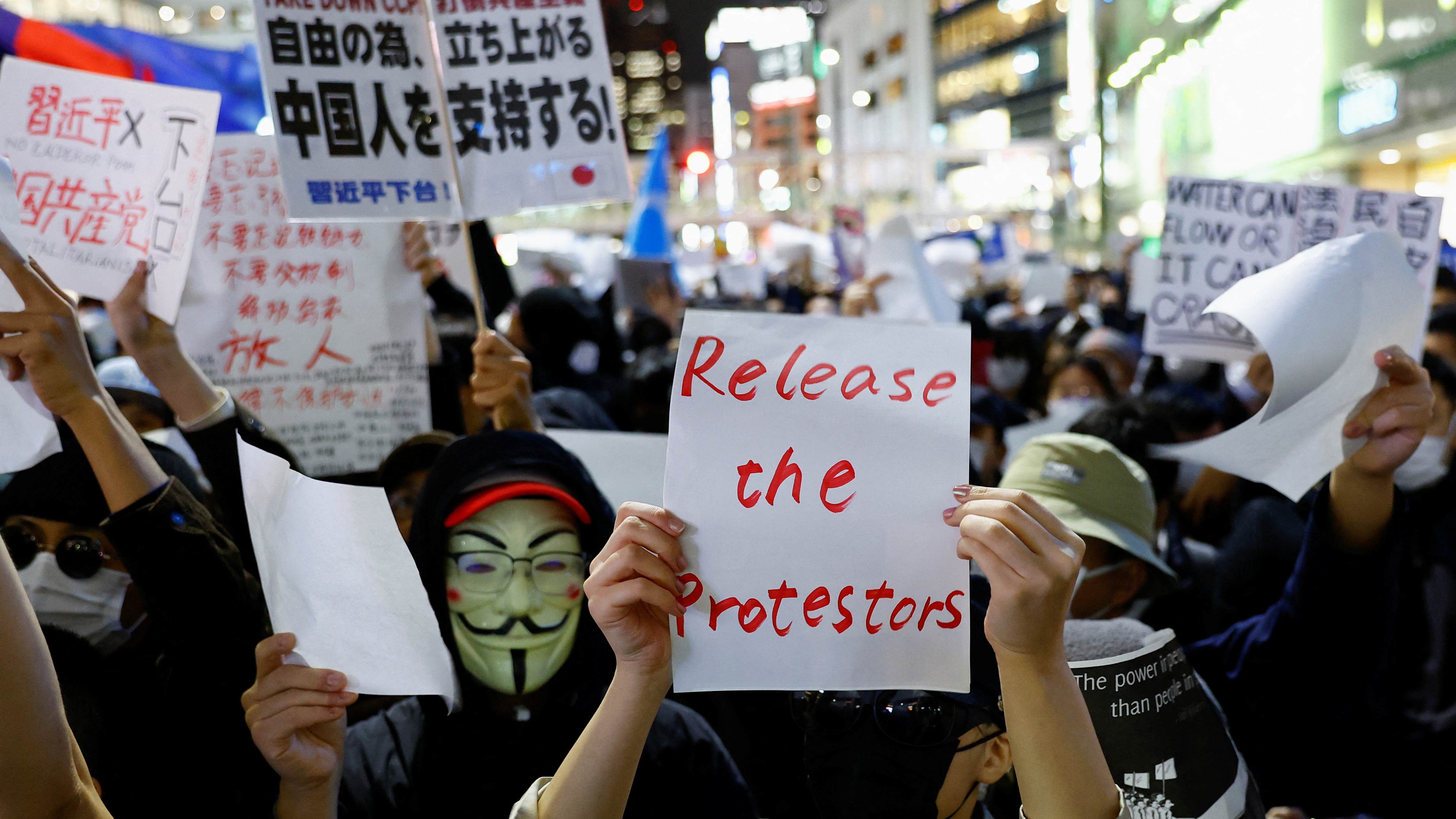 Chinese residents living in Japan take part in a solidarity protest against China's Covid-19 lockdowns, in Tokyo, Japan. Credit: Reuters Photo