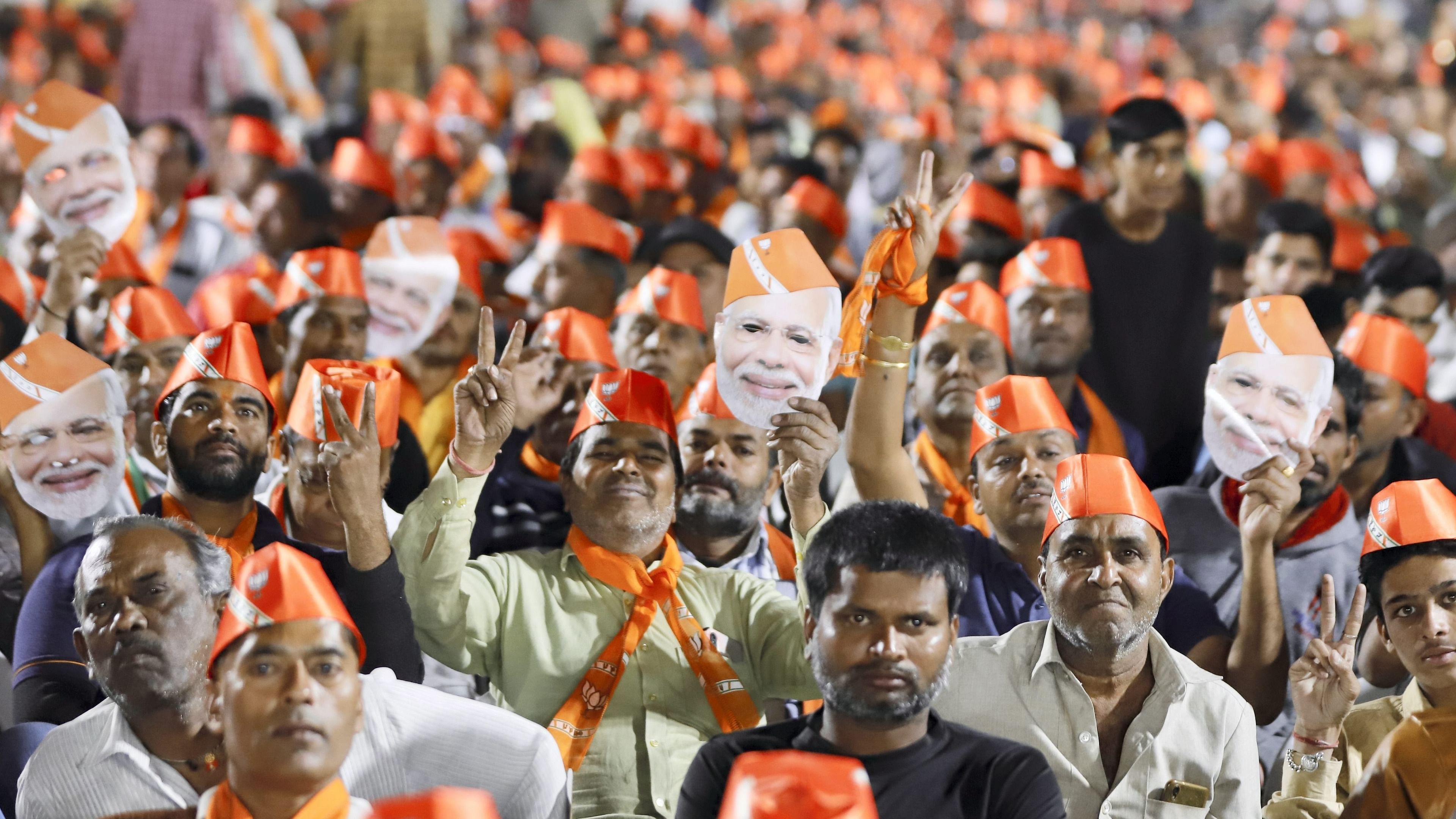 Supporters of BJP attend public meeting of Union Home Minister Amit Shah ahead of Gujarat Assembly election in Ahmedabad. Credit: PTI Photo
