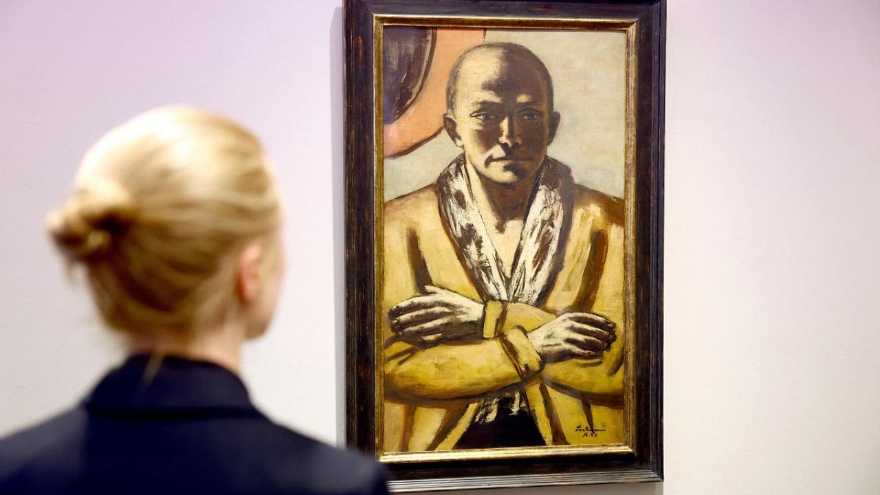 A woman looks at a self-portrait of German artist Max Beckmann 'Selbstbildnis gelb-rosa 1943 Amsterdam'. Credit: Reuters Photo