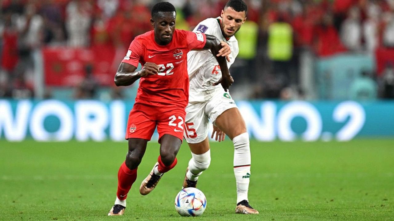 Canada's defender #22 Richie Laryea (L) and Morocco's midfielder #15 Selim Amallah fight for the ball during the Qatar 2022 World Cup. Credit: AFP Photo
