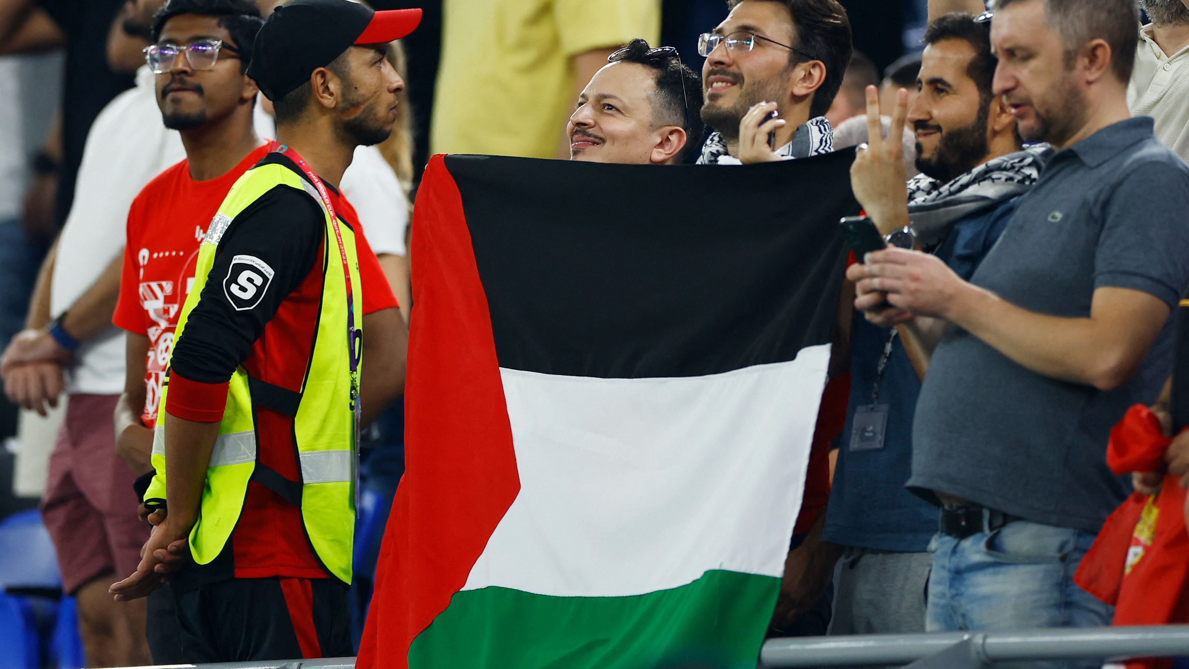 Fans display the flag of Palestine inside the stadium before the match. Credit: Reuters Photo