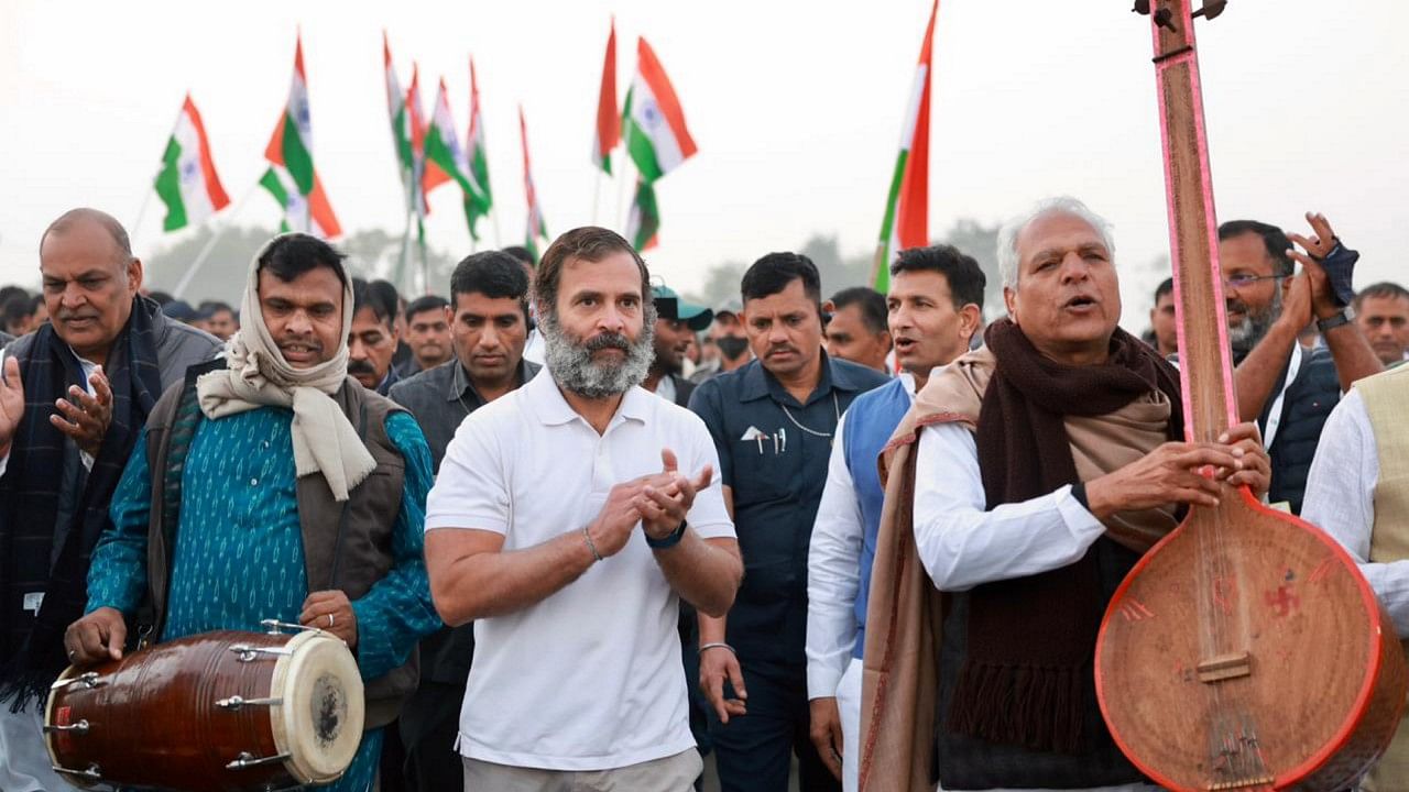 Noted folk singer Prahlad Tipanya along with his group and Congress MLA Jitu Patwari were seen walking with Gandhi. Credit: PTI Photo