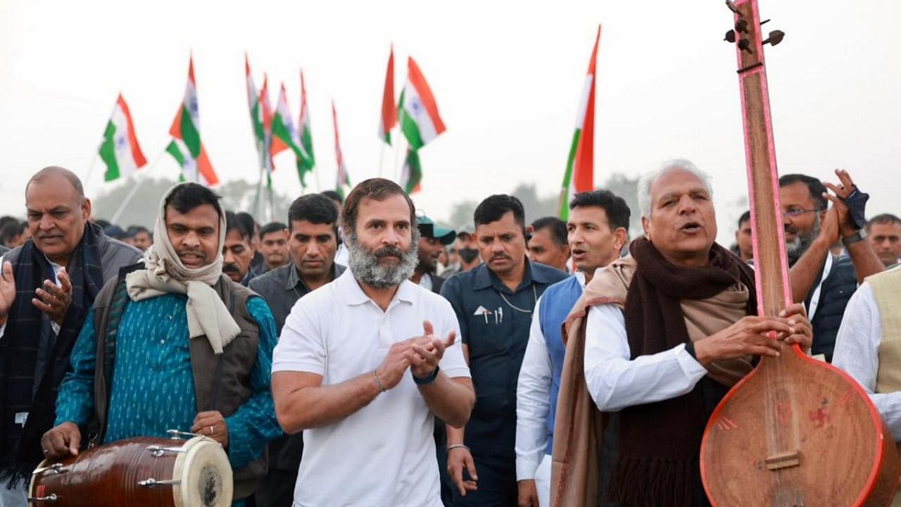 Congress leader Rahul Gandhi with folk singer Prahlad Singh Tipaniya and other supporters during the party's Bharat Jodo Yatra, in Lala Khedi village, Madhya Pradesh. Credit: PTI Photo