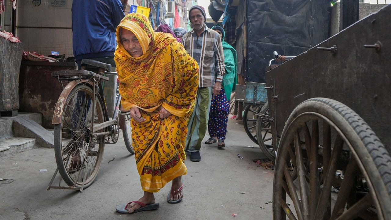  Amina Bi, 105, goes to a polling station without seeking any help to cast her vote for the MCD poll. Credit: PTI Photo